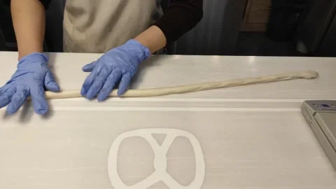 Preparing dough for pretzels making Stock Footage 259535446