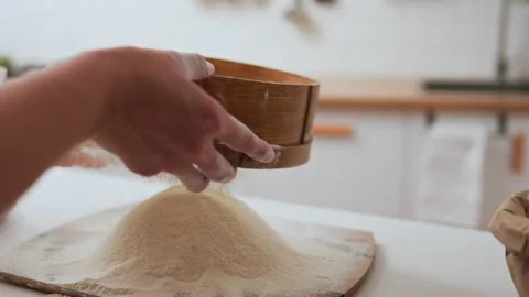 Preparing dough, Professional chef quickly sifting flour with a sieve home b Vídeo Stock 234428689