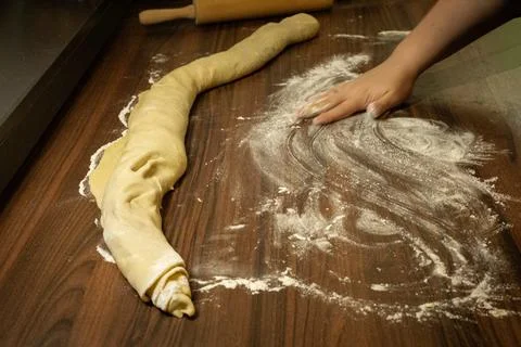 Preparing dough before slicing. Baking step in homemade cinnamon roll process Stock Photos