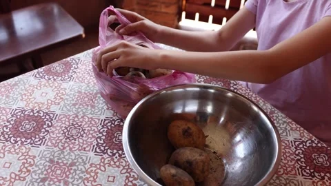 Preparing dough using a mixing bowl and ingredients in a cozy kitchen Stock Footage 297358343