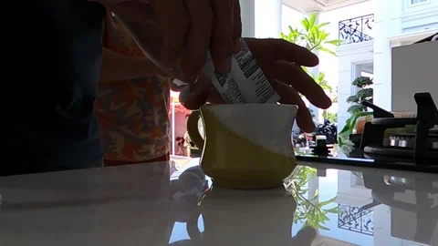 Preparing a drink in a small yellow and white cup Stock Footage 279445345