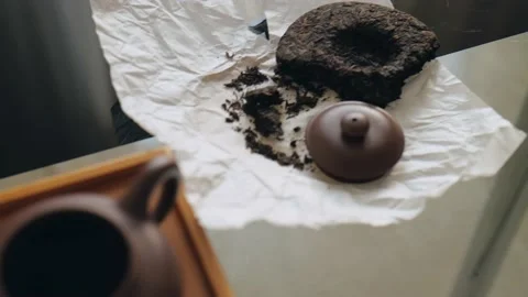 Preparing to drink tea from a clay teapot. Dark pressed shu pu-erh. Stock Footage 218447421
