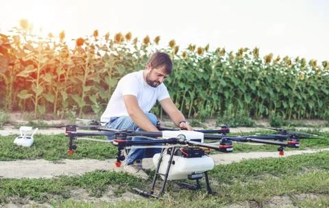 Preparing a drone for take off despite the sunset. 스톡 사진