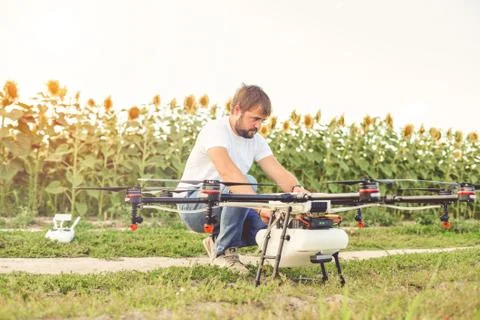 Preparing a drone for take off despite the sunset. Stock Photos