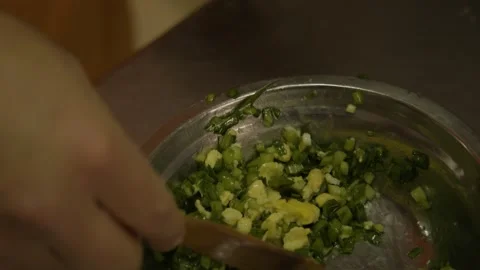 Preparing Dumpling Filling with Vegetables and Egg by Hand in Beijing Street Stock Footage 345882661