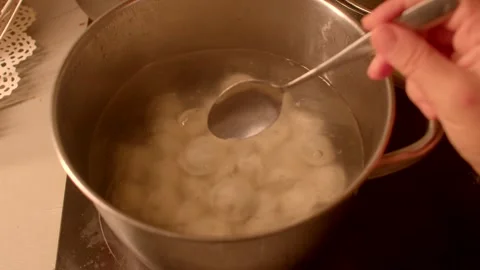 Preparing Dumplings by Cooking Them in Boiling Water Methodically Stock Footage 318924094