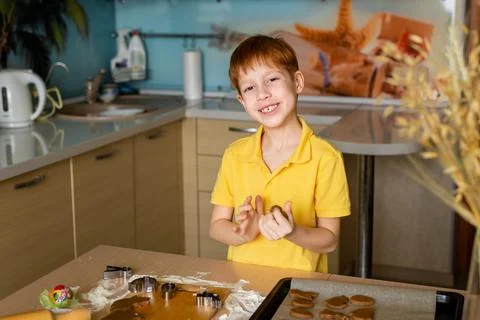 Preparing for Easter baking. Portrait of a child looking at the camera and sm Stock Photos