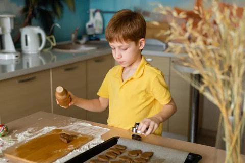 Preparing for Easter baking. Portrait of a red-haired boy child making dough  Stock Photos