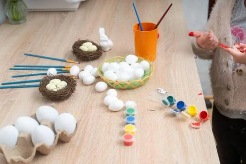 Preparing for Easter celebration decorating eggs with paint and brushes 写真素材