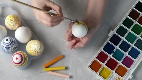Preparing for Easter. Close-up of hands painting Easter eggs Stock Footage 172091243