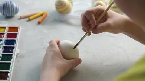 Preparing for Easter. Close-up of hands painting Easter eggs Stock Footage 172091259