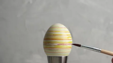 Preparing for Easter. Close-up of hands painting Easter egg Stock Footage 172430604