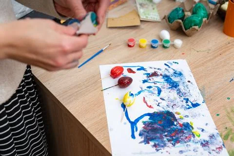 Preparing for Easter Sunday by painting eggs and creating artistic spring h.. Stock Photos