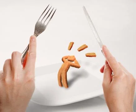 Preparing to eat a human shaped chicken nugget Stock Photos