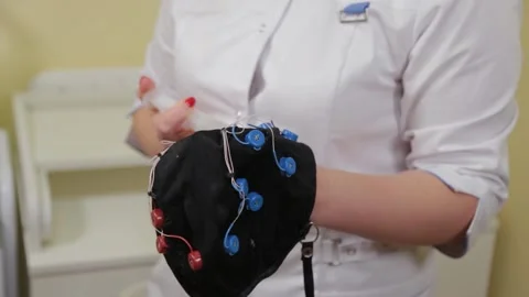 Preparing for an EEG analysis of the brain in the doctor's office. Installation Stock Footage 138178440