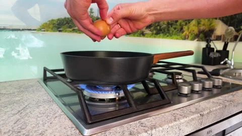 Preparing Egg for Breakfast on Gas Stove Stock Footage 307678129