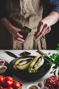 Preparing eggplants for baking and stuffing Stock Photos