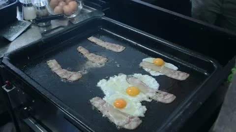 Preparing eggs bacon Stock Footage 21843344