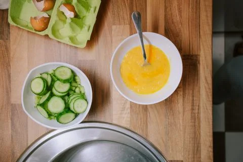 Preparing eggs for breakfast in home kitchen. Stock Photos