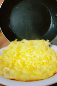 Preparing eggs for breakfast in home kitchen. Stock Photos