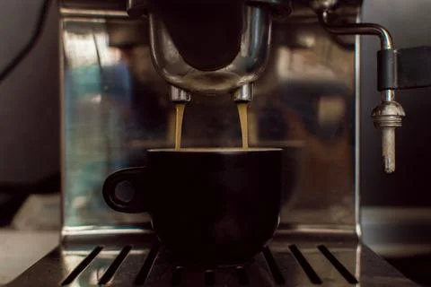 Preparing espresso in a coffee machine. Stock Photos