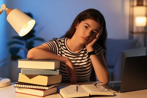 Preparing for exam. Student with books at table indoors Stock Photos