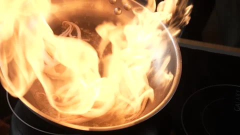 Preparing exotic fresh octopuses in metal frying pan with burning oil. Chef Stock Footage 171444327