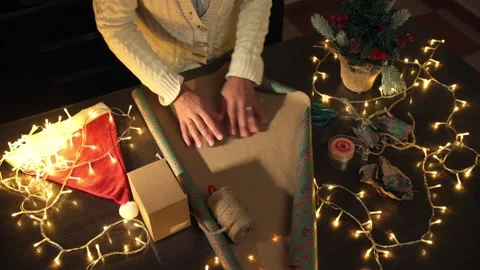 Preparing a Festive Gift with Warm Decorative Holiday Elements Stock Footage 316962094