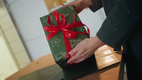 Preparing festive presents carefully. Hands meticulously wrapping Christmas gift Stock Footage 338285964