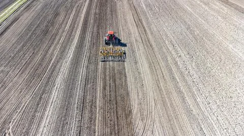 Preparing the field. Drone view of a tractor. Stock Photos