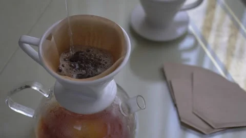 Preparing filter coffe pouring hot water Stock Footage 254905404