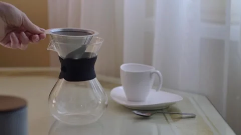 Preparing filter coffe, putting metal filter on pot Stock Footage 254905247