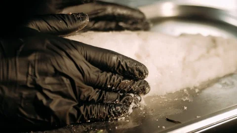 Preparing a fish crusted in salt Stock Footage 125458437
