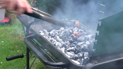 Preparing a flame for a barbecue Stock Footage 289564866
