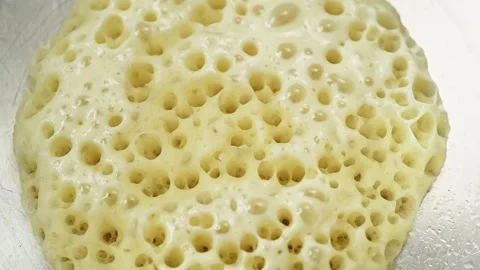 Preparing of fluffy Moroccan pancake in a frying pan. Stock Footage 240376785