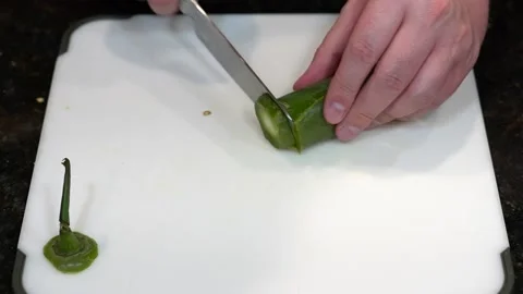Preparing Food By Cutting On A Plastic Cutting Board In A Kitchen Video stock 139724308