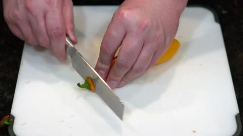 Preparing Food By Cutting On A Plastic Cutting Board In A Kitchen Stock Footage 139769499