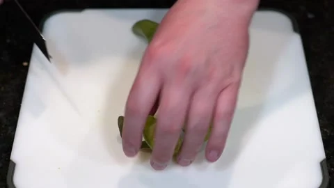 Preparing Food By Cutting On A Plastic Cutting Board In A Kitchen Stock Footage 139770048