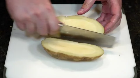 Preparing Food By Cutting On A Plastic Cutting Board In A Kitchen Stock Footage 139770073