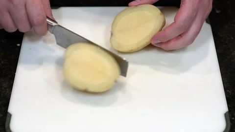 Preparing Food By Cutting On A Plastic Cutting Board In A Kitchen Stock Footage 139770089
