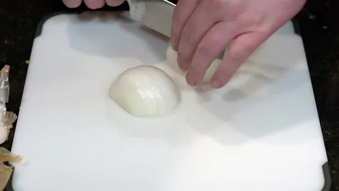 Preparing Food By Cutting On A Plastic Cutting Board In A Kitchen Stock Footage 139770145