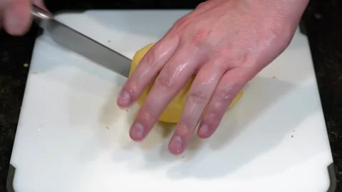 Preparing Food By Cutting On A Plastic Cutting Board In A Kitchen Stock Footage 139770146
