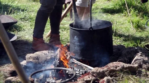 Preparing food in pot over the fire Stock Footage 64754318