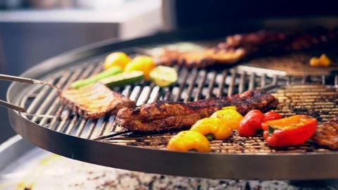 Preparing food on rotating barbecue Stock Footage 118891607