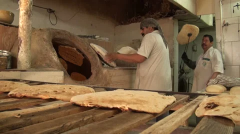 Preparing fresh bread in Iran bakery Stock Footage 34090244