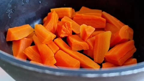 Preparing Fresh Carrot Slices in Pot for Family Dinner Stock Footage 341459266