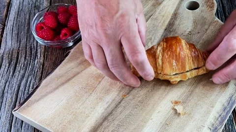 Preparing fresh croissants with raspberry jam for breakfast, time lapse Stock Footage 333774742