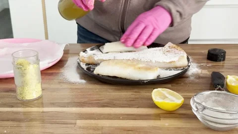 Preparing fresh fish and adding spices in a kitchen Vídeos de archivo 335165499