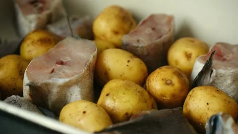 Preparing fresh fish steaks with potatoes for baking Stock Footage 337902135