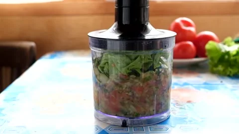 Preparing a fresh, healthy vegetable smoothie drink in a blender Stock Footage 189317981
